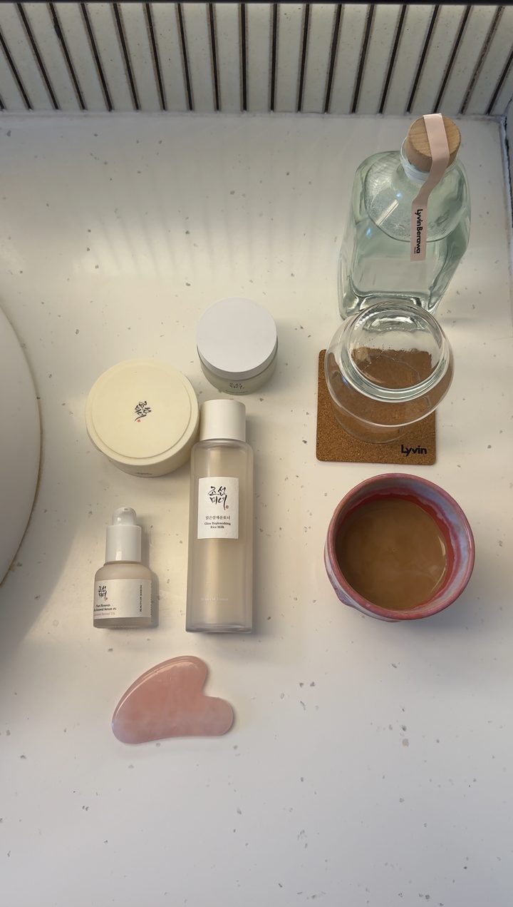 Skincare flat lay with a gua sha
