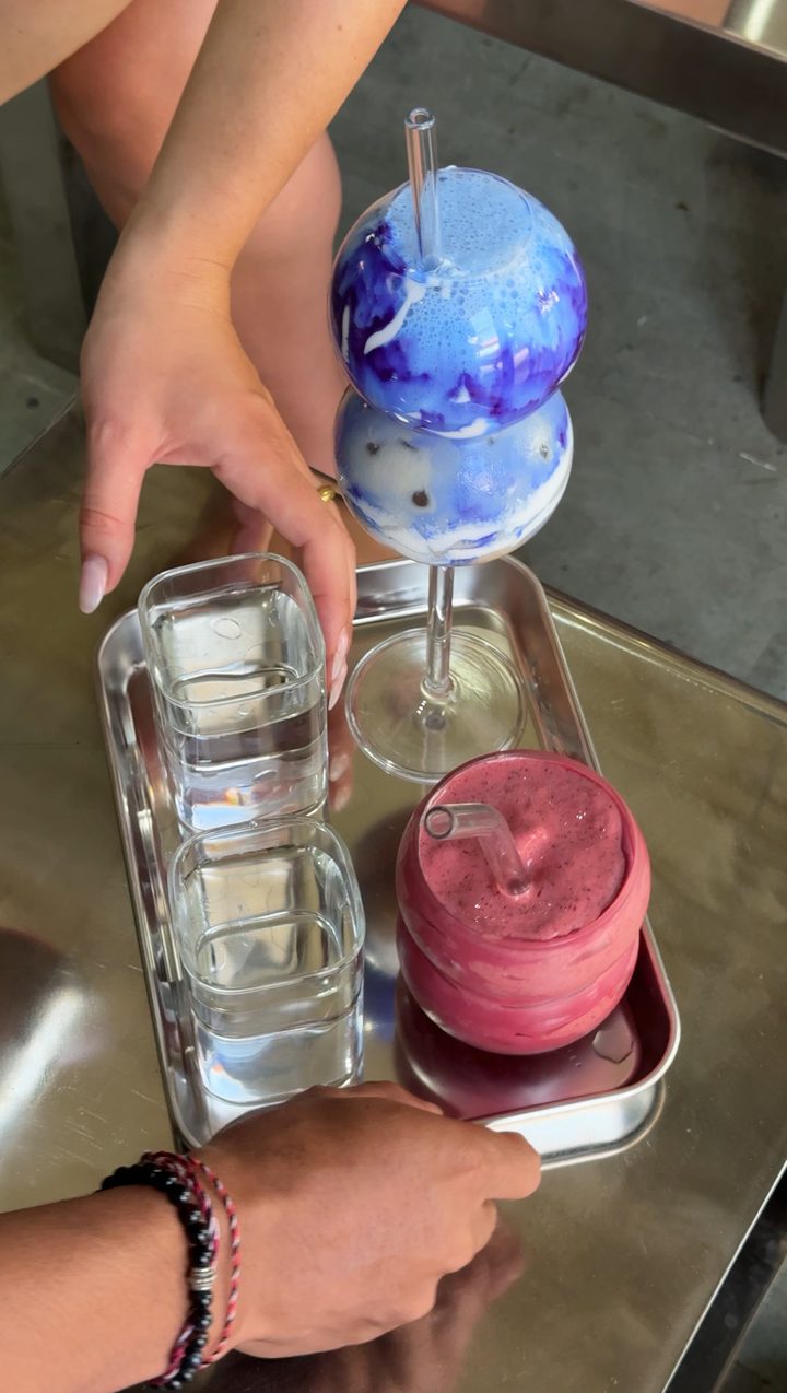 Colourful drinks being mixed on a tray