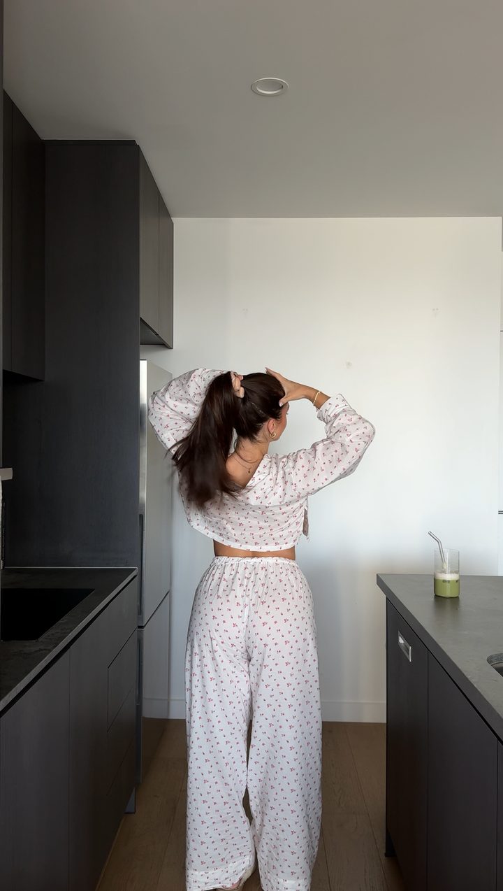 Laura in patterned pyjamas in a kitchen